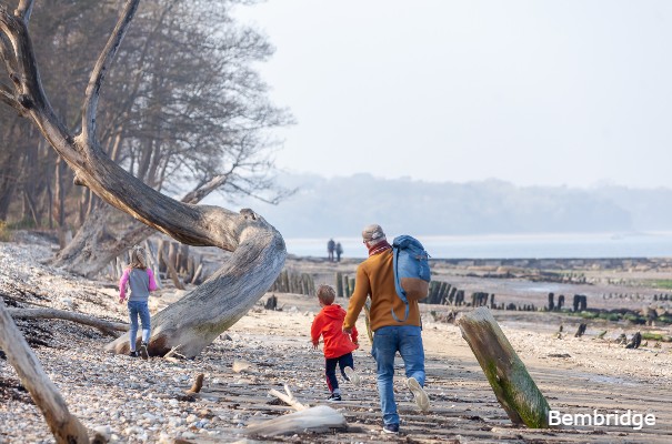 Family walking across Bembridge beach